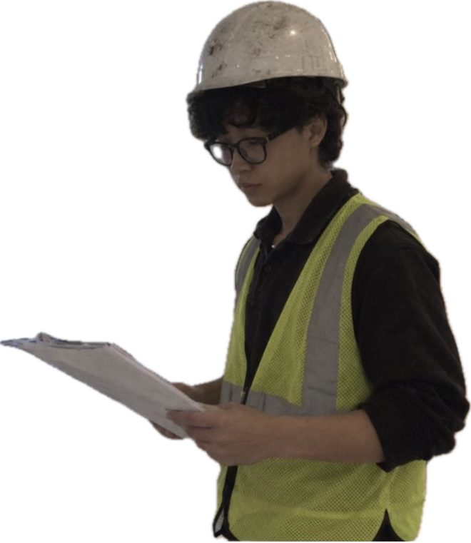 Junhong Liao reading drawings on a renovation job site